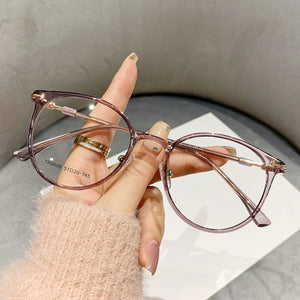 Translucent round frame eyeglasses in a muted purple hue with gold accents.
