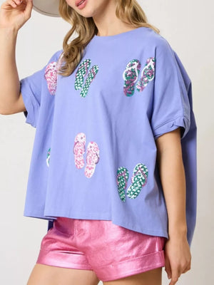 Blue polyester t-shirt with all-over flip-flop print and short sleeves.