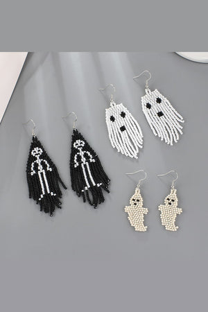 Beaded ghost and skeleton fringe earrings in ivory, black, and white.