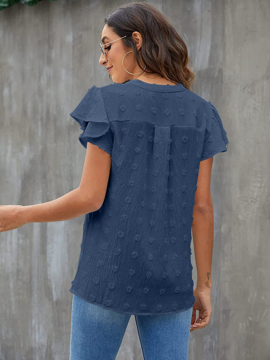 Textured voile blouse in dark blue with flutter sleeves and dotted pattern.