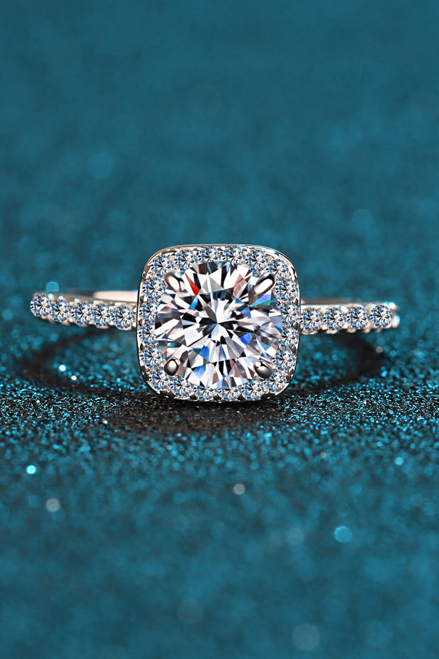 Silver cushion halo engagement ring with pave band