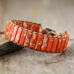 Jasper wrap bracelet in orange with white marbling on leather cord.
