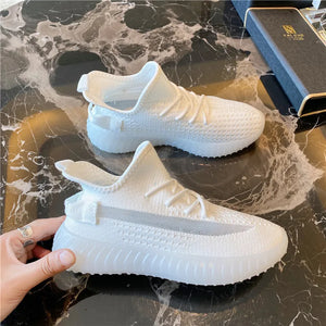 White textured knit platform sneakers with translucent soles and a pull tab.