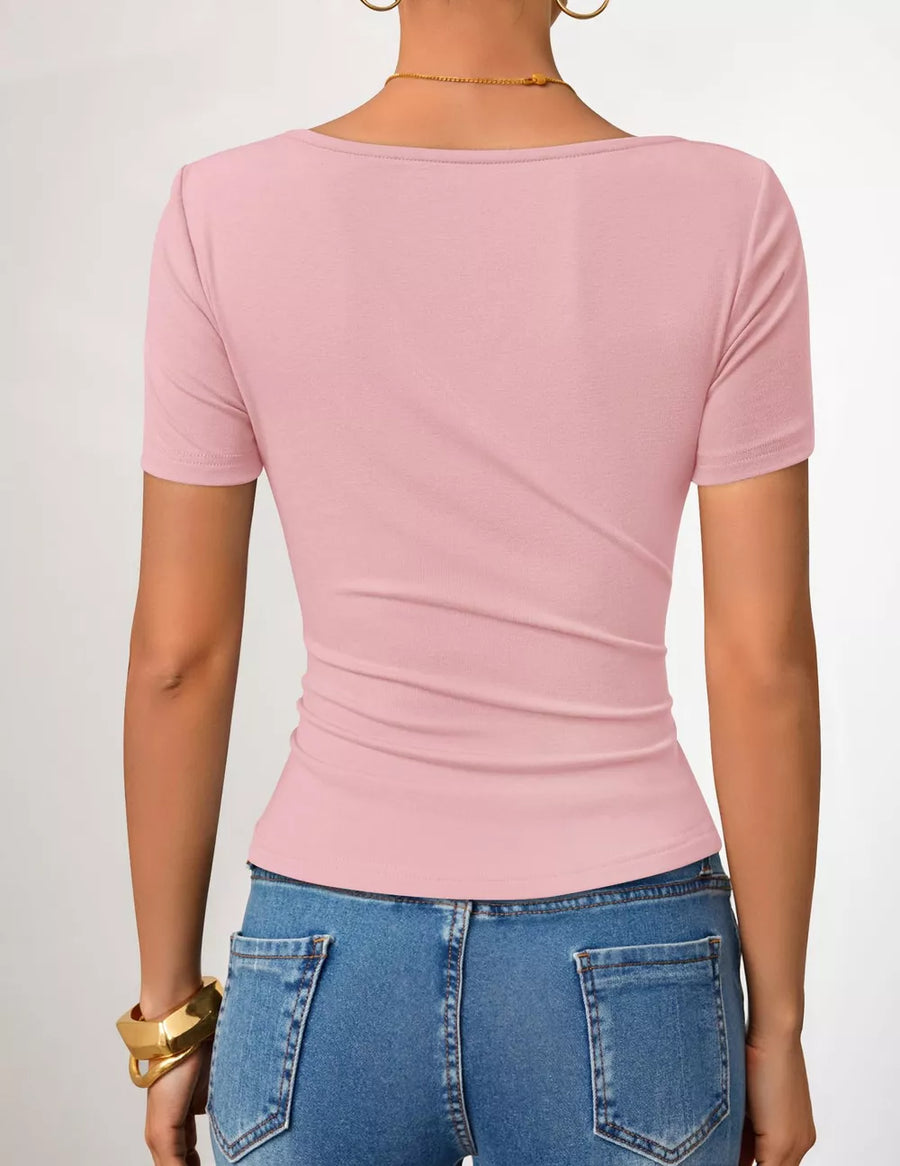 Pink maternity t-shirt with short sleeves and a fitted silhouette, showing the back detail.