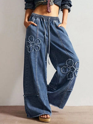 wide-leg jeans in medium blue featuring distressed and flared fit