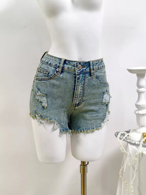 denim shorts in light blue featuring distressed and regular fit