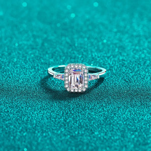 Emerald cut moissanite halo ring in sterling silver with baguette accents