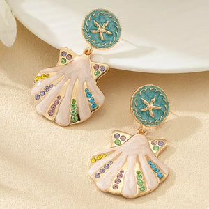 light pink earrings featuring dangle and motif