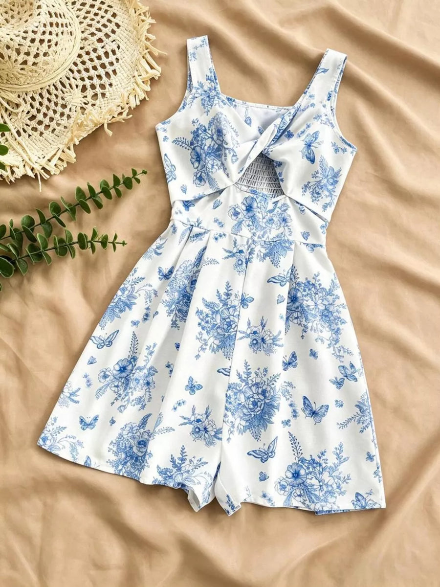 White floral print romper with blue flowers and butterflies, twist front, cutout, smocked waist.