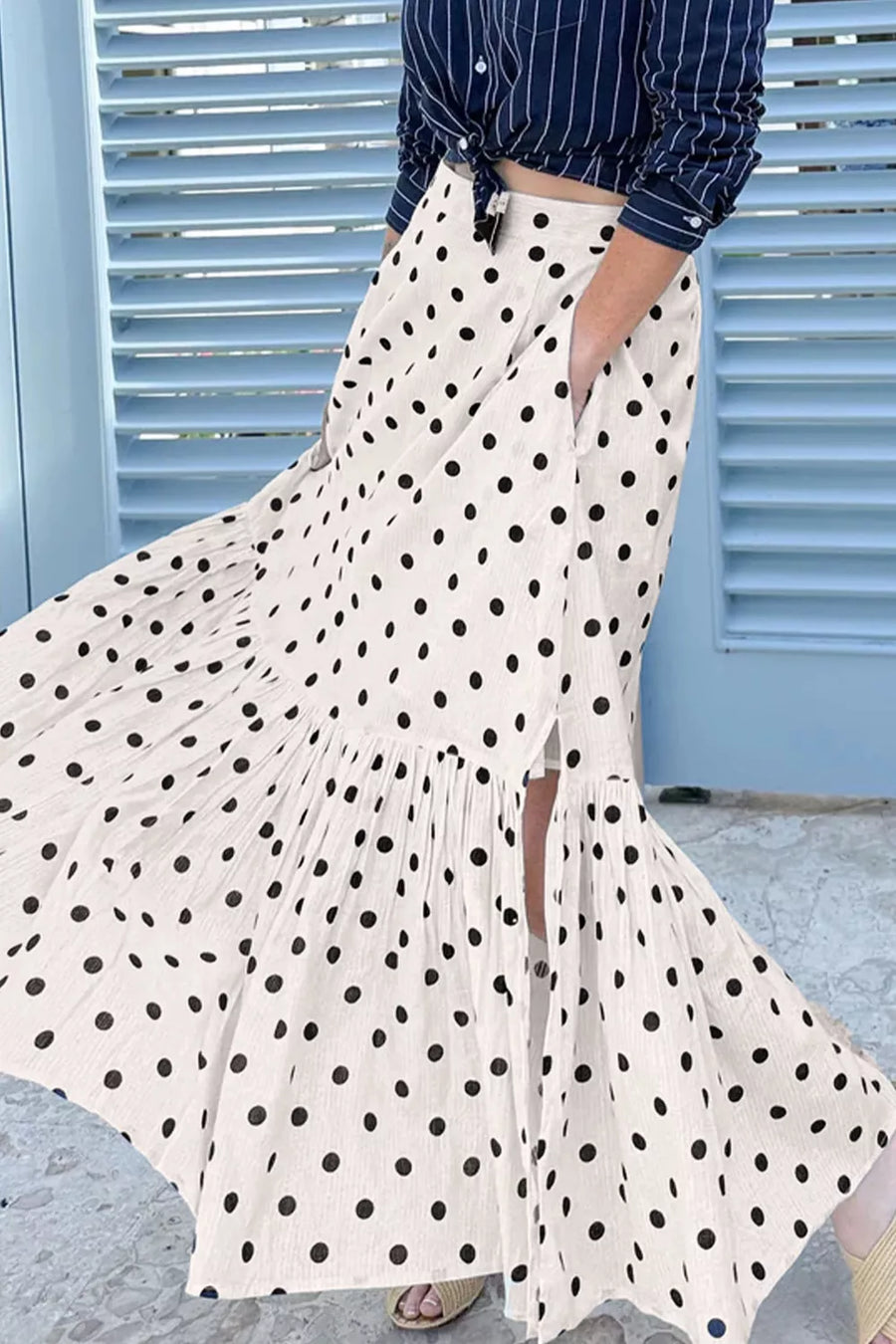 Chic polka dot maxi skirt in beige with ruffled hem and side pockets.
