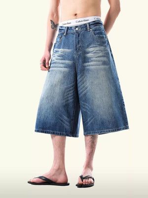 Relaxed fit light blue denim capris with whiskering detail and wide leg.