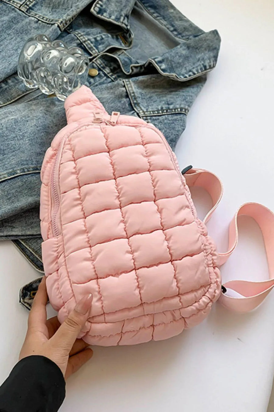 Padded sling bag in blush pink with quilted pattern and top handle