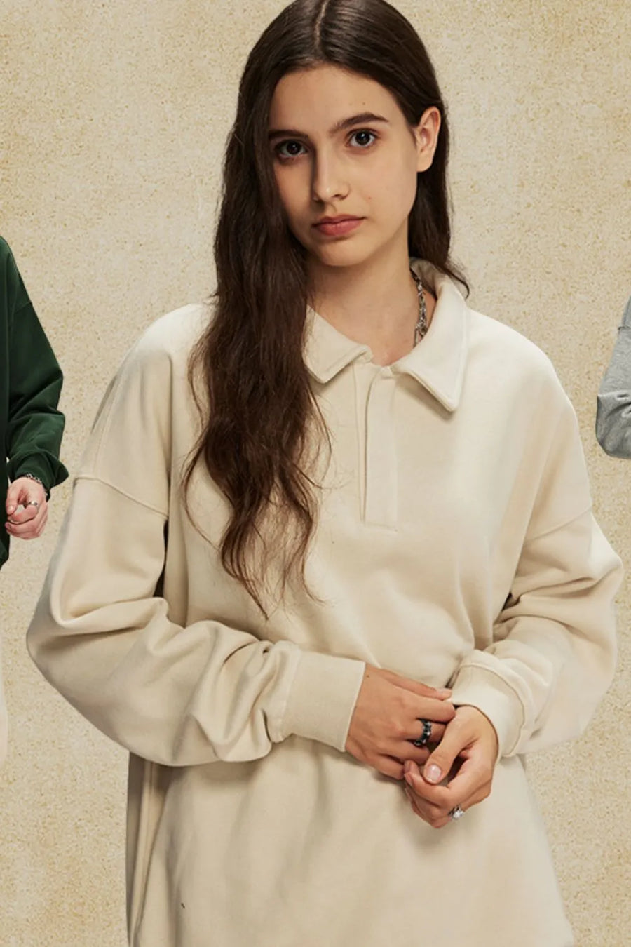 Oversized tan polo sweatshirt with collar and long sleeves.