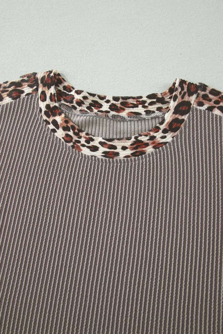 Ribbed knit two-piece set with leopard trim neckline and cuffs.