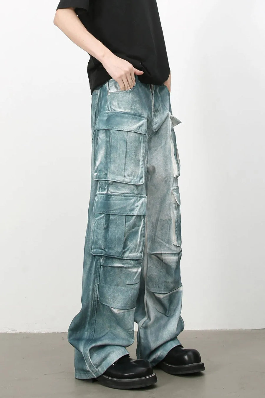 Bleached denim utility trousers in medium with multiple cargo pockets and a relaxed fit.