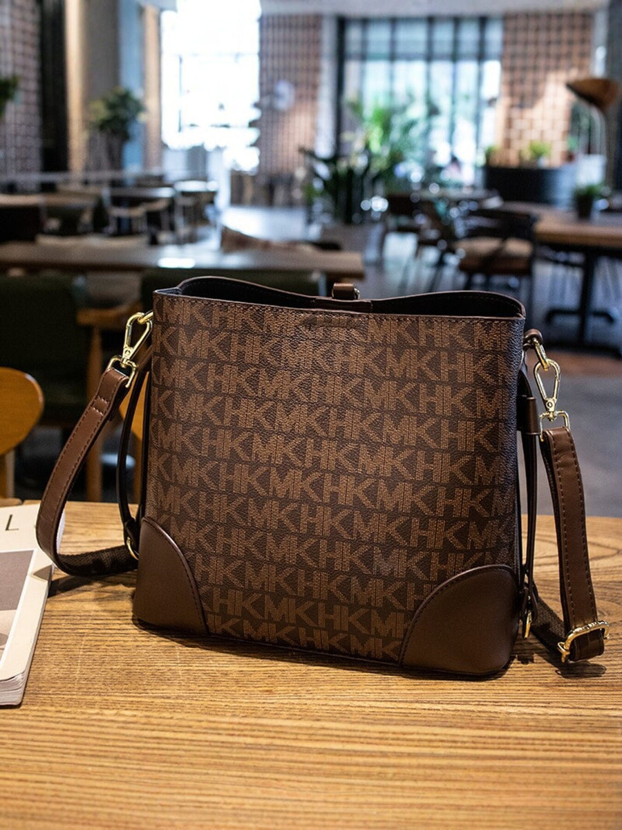 crossbody bag featuring monogram in Caramel with PU Leather Imported Size & texture