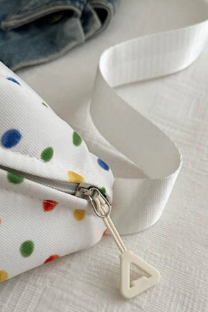 White belt bag with colorful polka dots and a white strap.