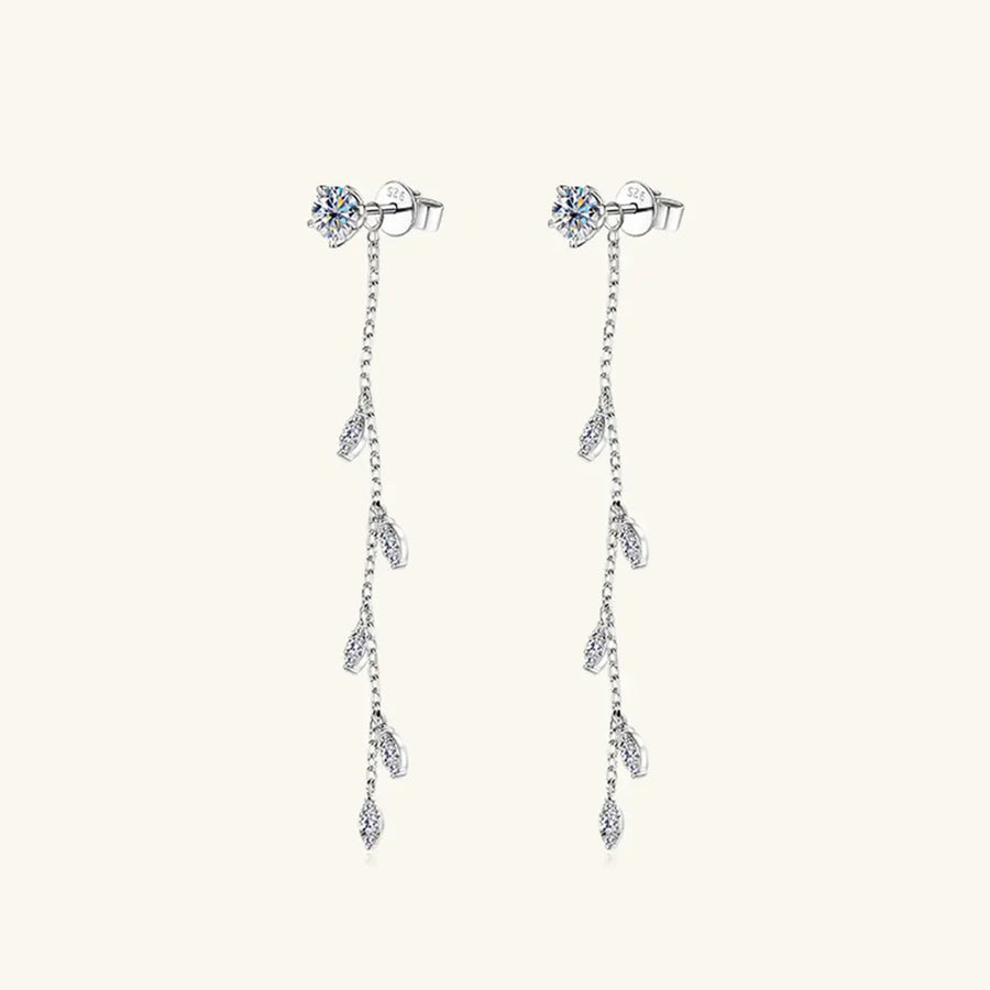Silver dangling crystal vine earrings with delicate chain and leaf-shaped accents.