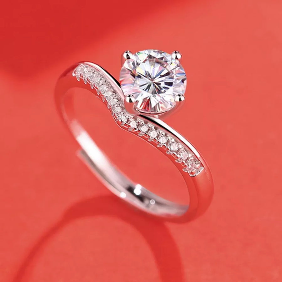 Sterling silver ring with a large brilliant moissanite and pave accent stones.
