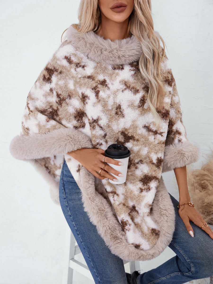Faux fur trimmed camo poncho in chocolate with a fuzzy texture and relaxed fit.