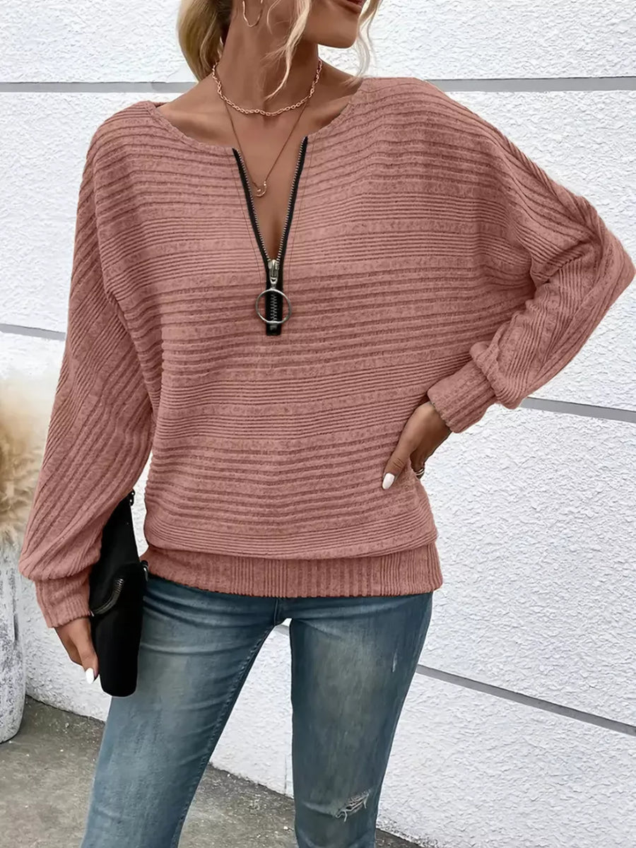 Pink ribbed acrylic sweatshirt with O-ring quarter zip and dolman sleeves.