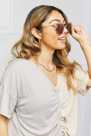 Tortoiseshell round frame sunglasses with tan frames and brown lenses.