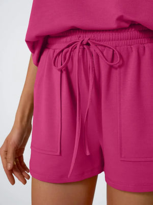 Hot Pink drawstring shorts with elastic waistband and patch pockets.