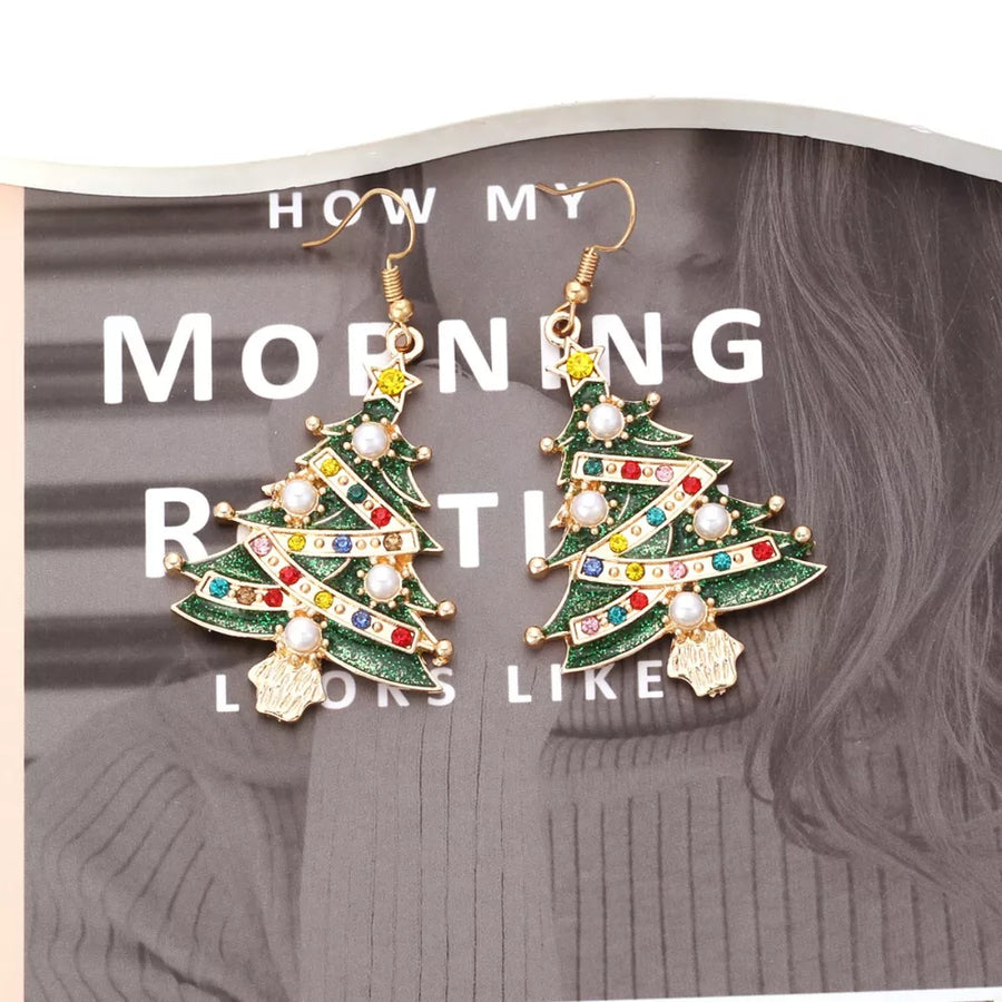 gold earrings featuring dangle and figurative