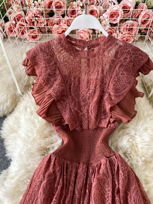 Elegant ruffled lace maxi dress in rose pink with pleated short sleeves and a cinched waist.