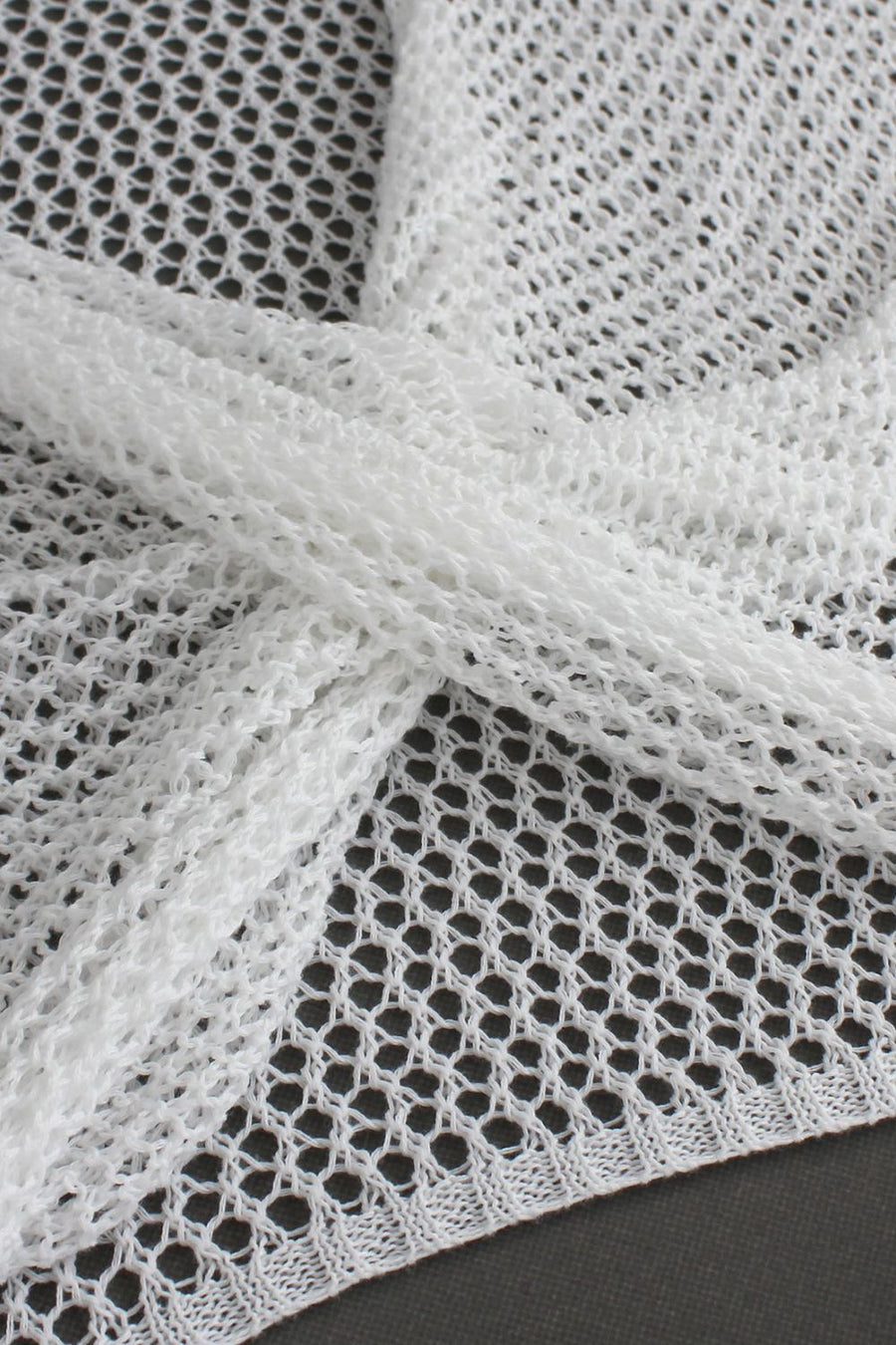 White crochet blouse with open knit detail and pearl chain accent