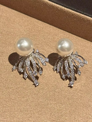 Luminous pearl and zircon silver earrings with intricate detailing.