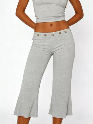 Light gray flared hem capri pants with button detail at waist