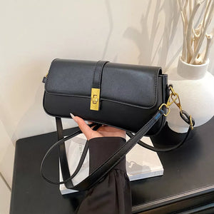 Sleek black rectangular crossbody bag with gold clasp and strap hardware.