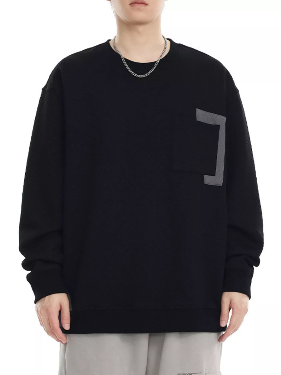 Black crew neck sweatshirt with textured fabric and chest pocket detail