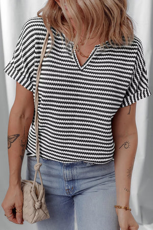 Textured knit t-shirt with notched neck and short sleeves in black and white stripes.