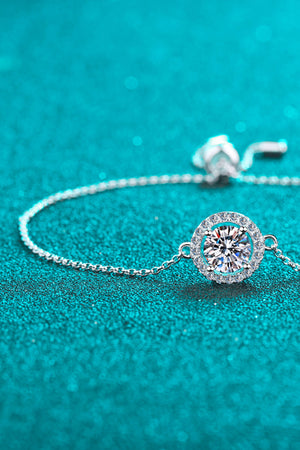 Silver adjustable bracelet with a round halo moissanite center stone.