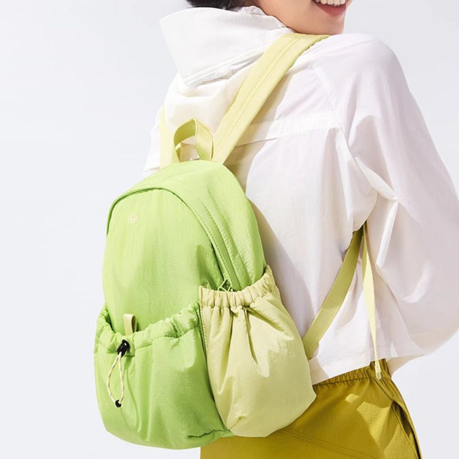 Mini lightweight nylon drawstring backpack in Gum Leaf green with side pockets and adjustable straps.