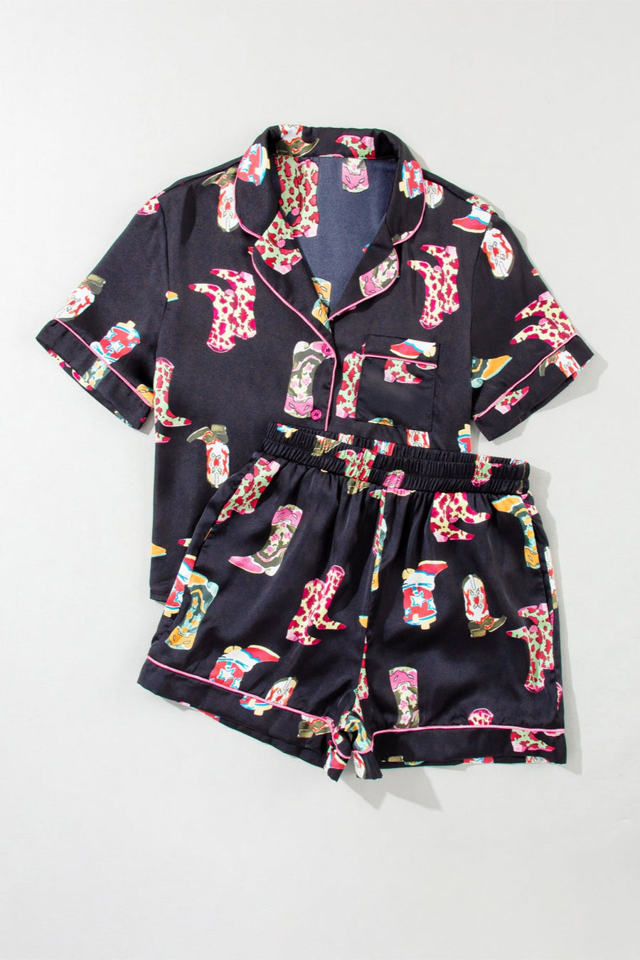 Black silk pajama set with colorful boot print and pink piping.