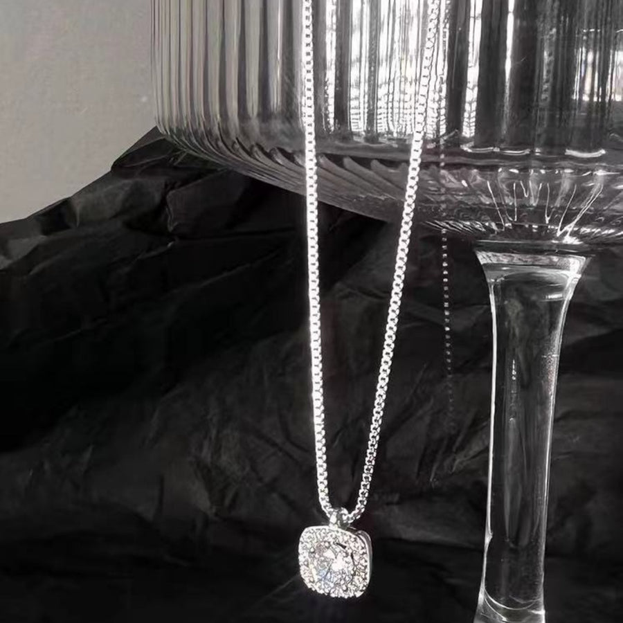 Sterling silver square pendant necklace with dazzling stones on a delicate chain.