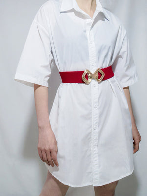 Red elasticated waist belt with gold geometric buckle detail