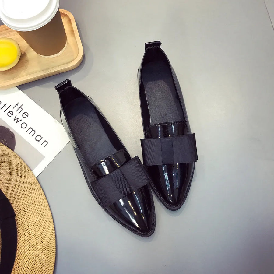 Black patent leather loafers with bow detail