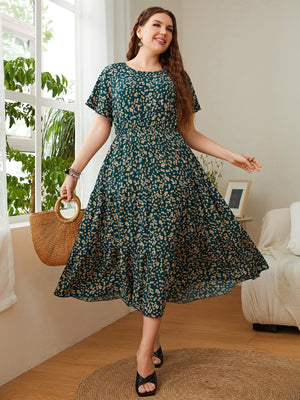 Emerald floral midi dress in deep teal with flutter sleeves and tiered skirt.