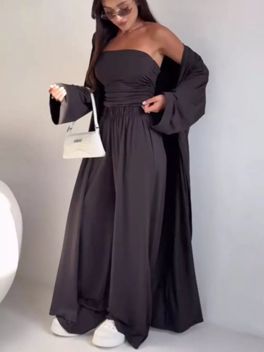 Chic three-piece dark gray maternity set with ruched bandeau top, wide-leg pants, and flowing cardigan.