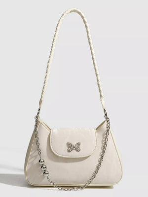 White shoulder bag with butterfly charm and beaded chain detail
