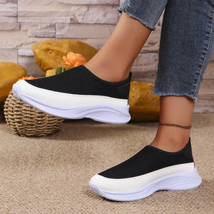 Black mesh slip-on sneakers with white sole and stripe detail.