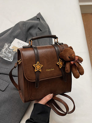 Star-Embellished Convertible Backpack Bag in brown with top handle