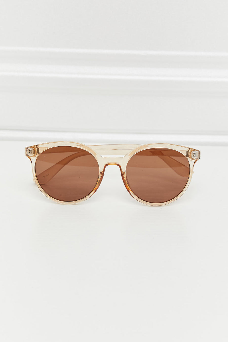 Tortoiseshell round frame sunglasses with tan translucent frames and brown lenses.