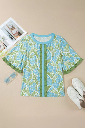Floral ruffled half sleeve maternity blouse with blue and green floral print and front ruffle detail.