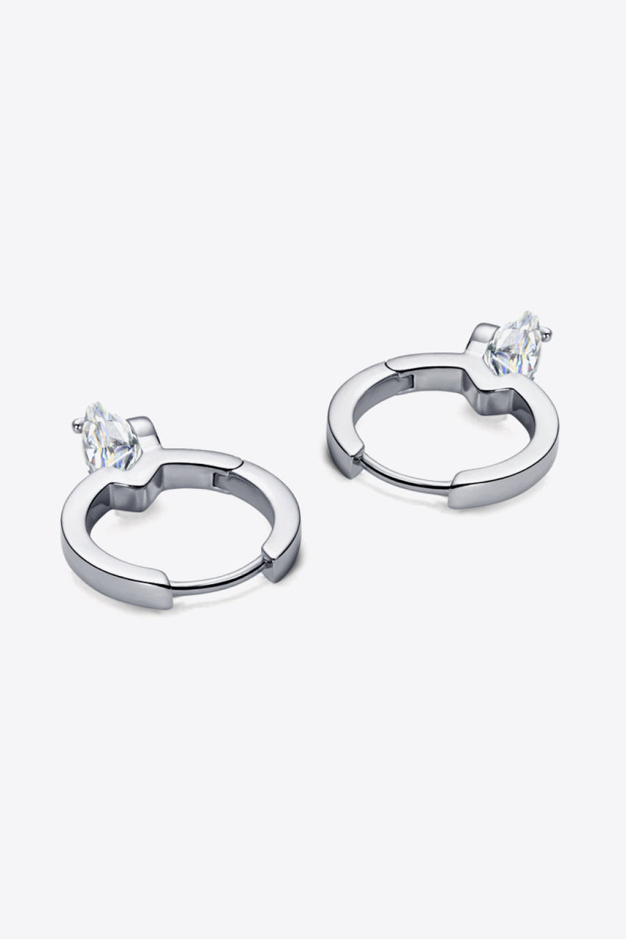 Silver huggie hoop earrings with a single marquise-cut gemstone accent.
