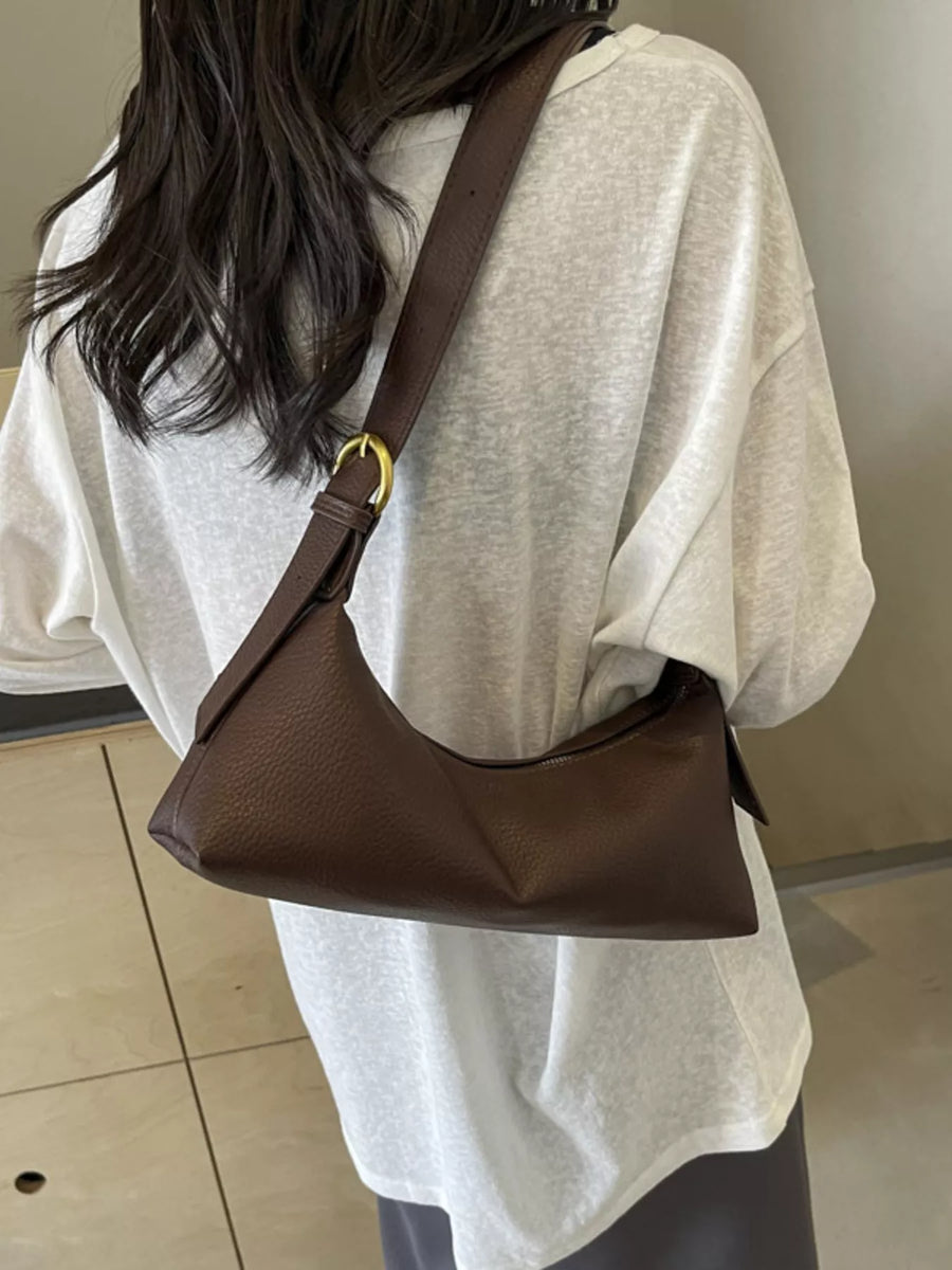 Brown minimalist PU leather crossbody bag with adjustable strap and gold buckle detail.